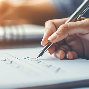 a hand holding a pencil