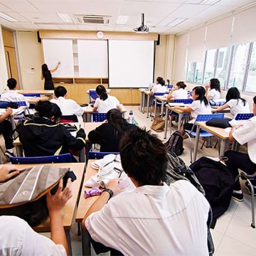 a classroom full of students and a teacher