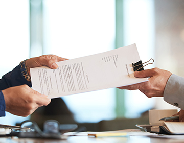 close-up: hands passing documents for application close-up: hands passing documents for application