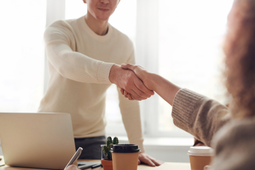 Two people handshaking Two people handshaking
