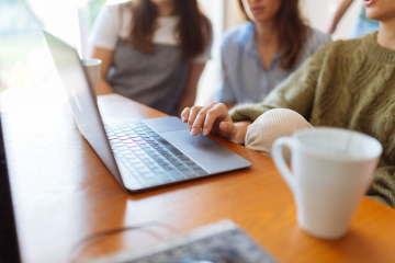 Three people using a computer Three people using a computer