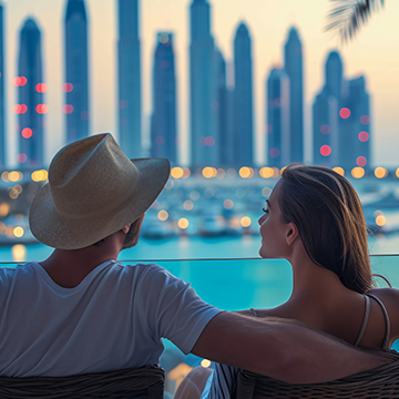 Couple relaxing at a Dubai rooftop lounge with skyline views at sunset, representing the chill nightlife in UAE. Couple relaxing at a Dubai rooftop lounge with skyline views at sunset, representing the chill nightlife in UAE.
