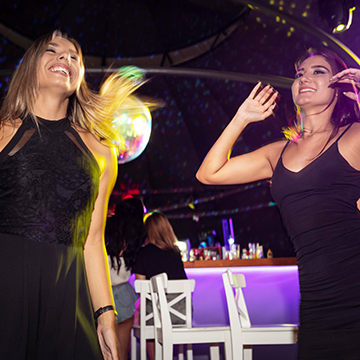 Women dancing in a Dubai nightclub, showcasing the vibrant UAE nightlife and high-energy party scene. Women dancing in a Dubai nightclub, showcasing the vibrant UAE nightlife and high-energy party scene.