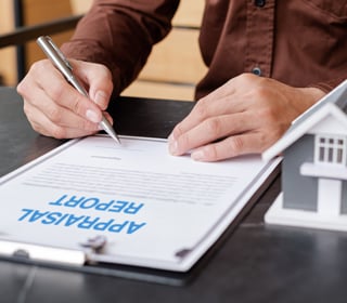 man-signing-appraisal-report man-signing-appraisal-report